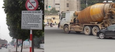 Cảnh sát giao thông đứng nhìn xe tải vào phố cấm